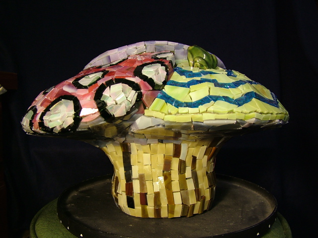 Mosaic mushroom about a foot tall made with stained glass.